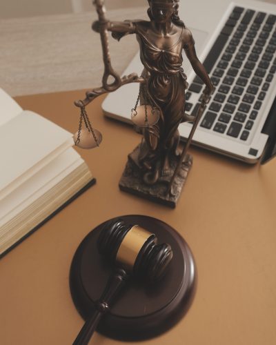 Business and lawyers discussing contract papers with brass scale on desk in office. Law, legal services, advice, justice and law concept picture with film grain effect