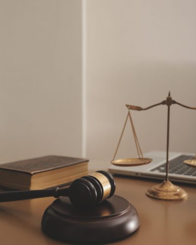 Business and lawyers discussing contract papers with brass scale on desk in office. Law, legal services, advice, justice and law concept picture with film grain effect